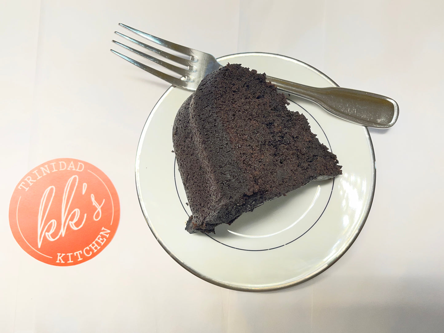 Slice of KK's Trinidad Kitchen Black Cake with fork