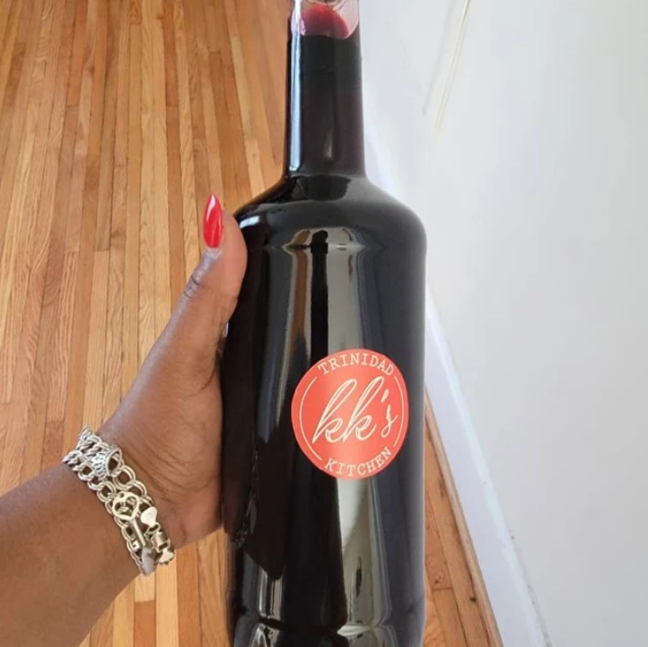 Hand holding a bottle of KK's Trinidad Sorrel with Rum